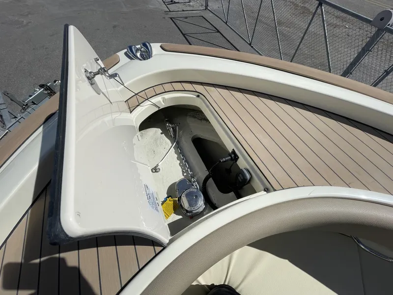 Slide: The Image of 2025 Chris-Craft Catalina 30 anchor compartment with open hatch, showcasing deck details. - 13