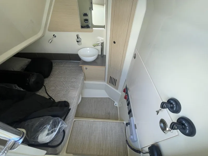 Slide: The Image of 2025 Chris-Craft Catalina 30 cabin interior with bed, sink, and storage. - 15