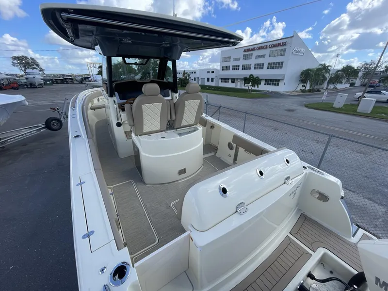 Slide: The Image of 2025 Chris-Craft Catalina 30 boat with spacious deck and seating, parked outdoors. - 3