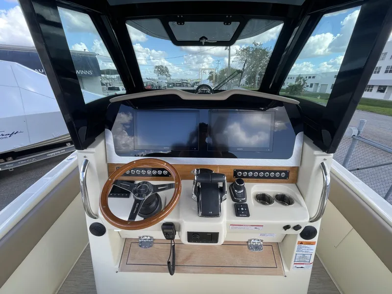 Slide: The Image of 2025 Chris-Craft Catalina 30 helm with modern controls and dual screens. - 8