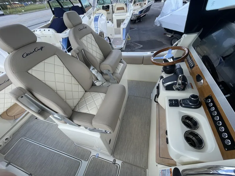 Slide: The Image of 2025 Chris-Craft Catalina 30 interior with luxury seating and modern helm controls. - 9