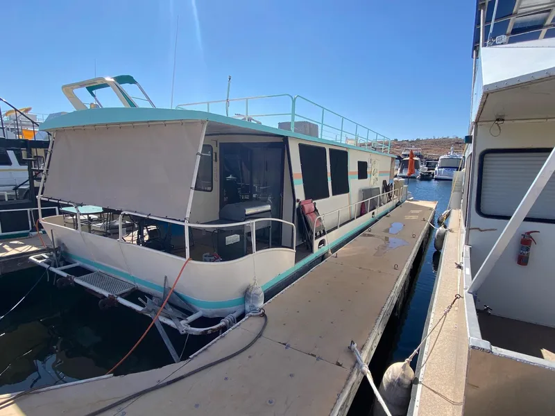 Slide: The Image of 1988 Boatel Hercules houseboat docked at marina under clear blue sky. - 1
