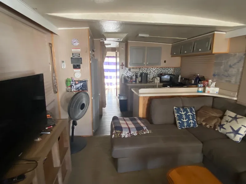 Slide: The Image of Interior of a 1988 Boatel Hercules houseboat with cozy living area and kitchen. - 10