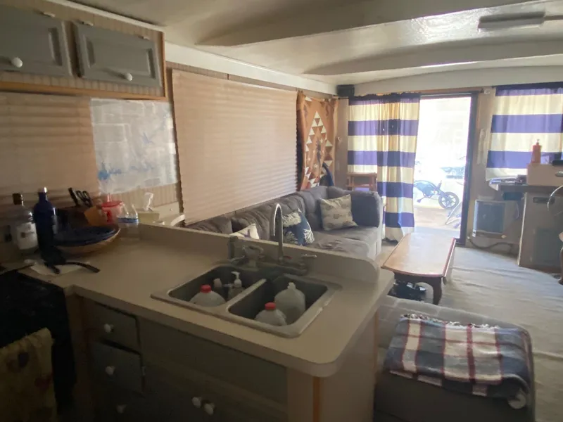 Slide: The Image of Interior of 1988 Boatel Hercules houseboat with cozy living area and kitchen. - 14