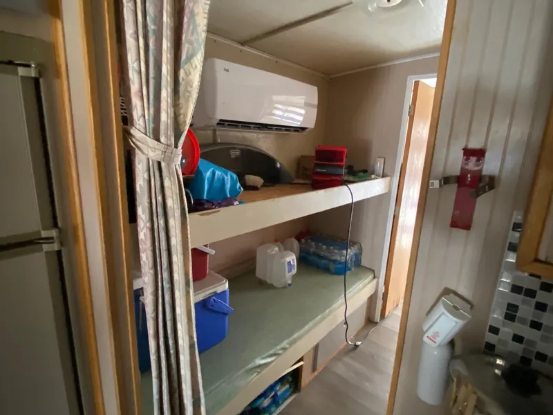 Slide: The Image of Interior of 1988 Boatel Hercules with bunk beds and storage. - 5