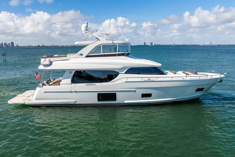 Slide: The Image of 2021 Ocean Alexander 70E Motoryacht cruising on open water under a clear sky. - 10