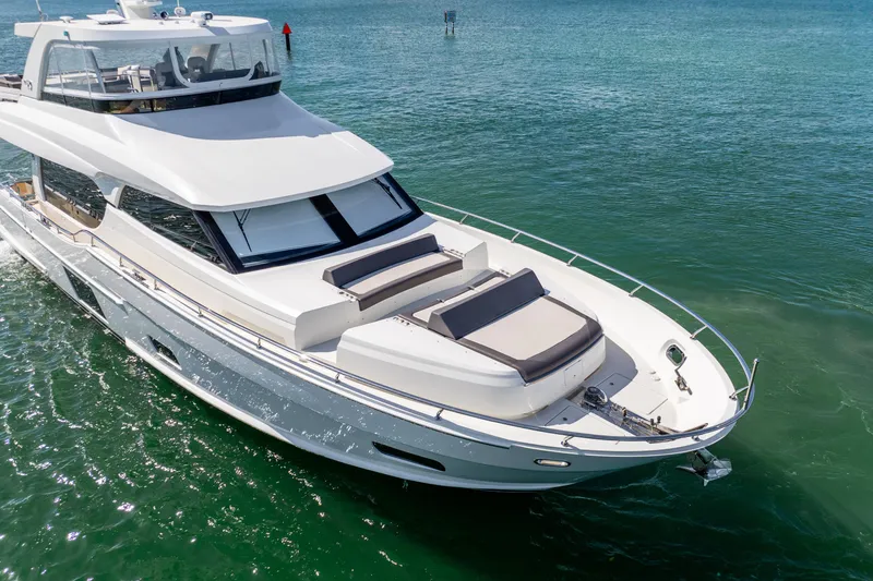 Slide: The Image of 2021 Ocean Alexander 70E Motoryacht cruising on clear green waters. - 12
