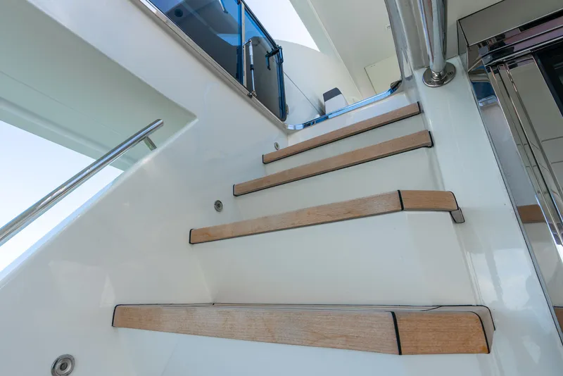 Slide: The Image of Staircase on 2021 Ocean Alexander 70E Motoryacht, featuring sleek wooden steps and modern design. - 21