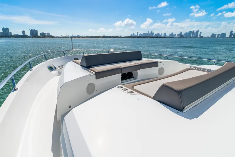 Slide: The Image of 2021 Ocean Alexander 70E Motoryacht on serene waters with city skyline. - 22