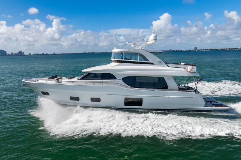 Slide: The Image of 2021 Ocean Alexander 70E Motoryacht cruising on open water under a clear blue sky. - 6