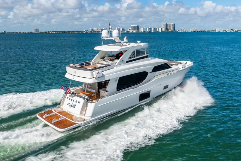 Slide: The Image of 2021 Ocean Alexander 70E Motoryacht cruising on blue ocean waters. - 7