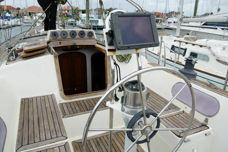Slide: The Image of Cockpit of 1980 Lafitte 44 Cutter sailboat with steering wheel and navigation equipment. - 14