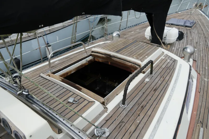 Slide: The Image of 1980 Lafitte 44 Cutter yacht deck with open hatch and wooden finish. - 18