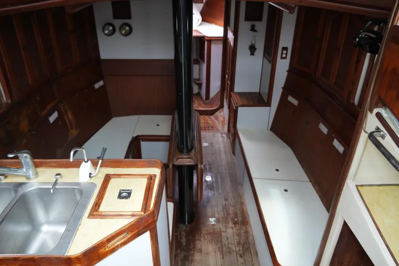 Slide: The Image of Interior of 1980 Lafitte 44 Cutter sailboat with wooden finishes and compact kitchen. - 19