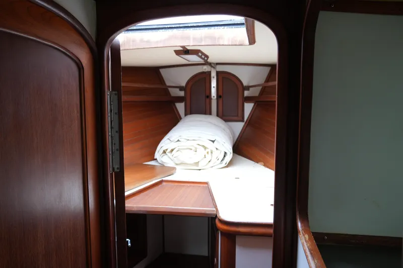 Slide: The Image of Interior cabin of 1980 Lafitte 44 Cutter sailboat with wooden finish and rolled sail. - 20