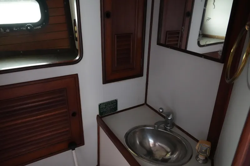 Slide: The Image of 1980 Lafitte 44 Cutter bathroom with stainless steel sink and wooden cabinetry. - 23