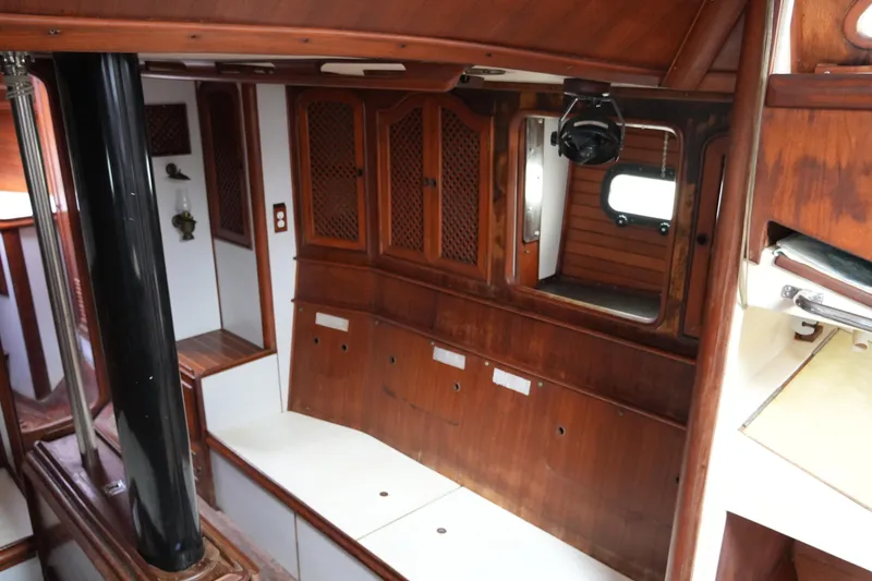 Slide: The Image of Interior of 1980 Lafitte 44 Cutter sailboat with wooden cabinetry and seating. - 28