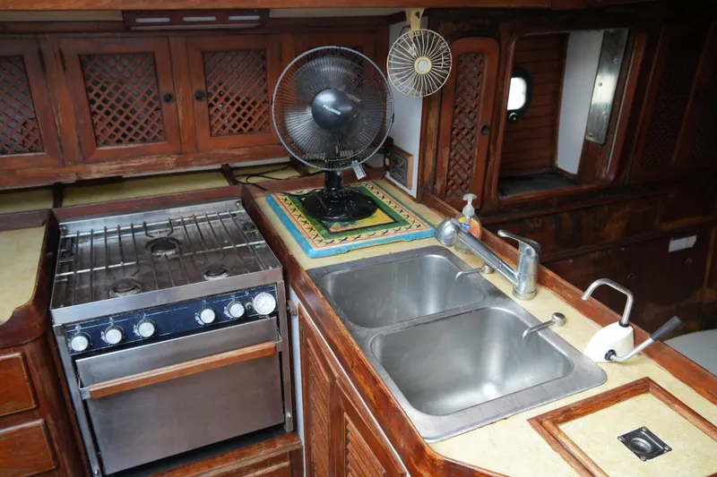 Slide: The Image of Galley kitchen in 1980 Lafitte 44 Cutter with stove, sink, and fan. - 31