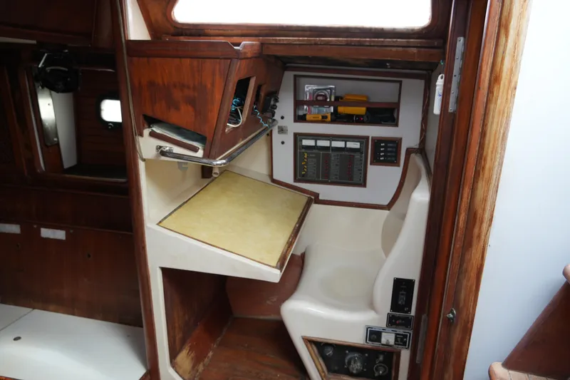 Slide: The Image of 1980 Lafitte 44 Cutter interior navigation station with wooden cabinetry and control panels. - 33