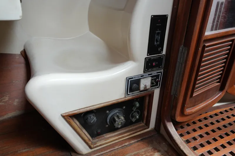 Slide: The Image of Interior controls of a 1980 Lafitte 44 Cutter sailboat, featuring wooden and fiberglass elements. - 35