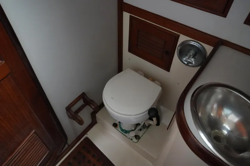 Slide: The Image of 1980 Lafitte 44 Cutter bathroom with toilet and stainless steel sink. - 37