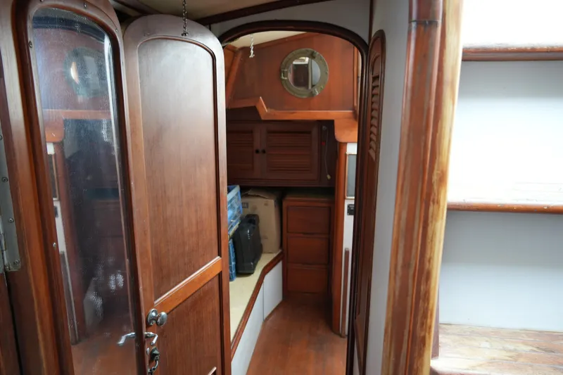 Slide: The Image of Interior of 1980 Lafitte 44 Cutter sailboat with wooden cabinetry and cozy cabin space. - 39