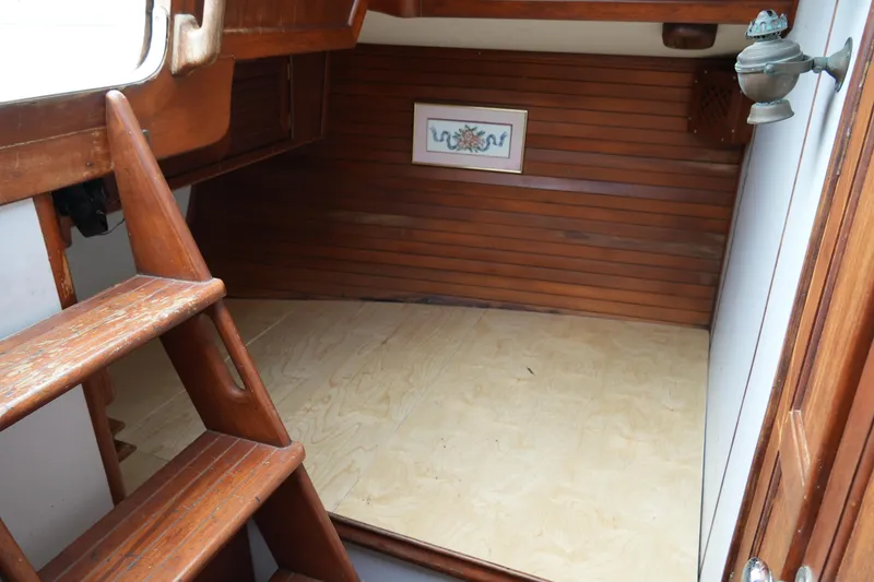 Slide: The Image of Interior of 1980 Lafitte 44 Cutter sailboat with wooden paneling and steps. - 40