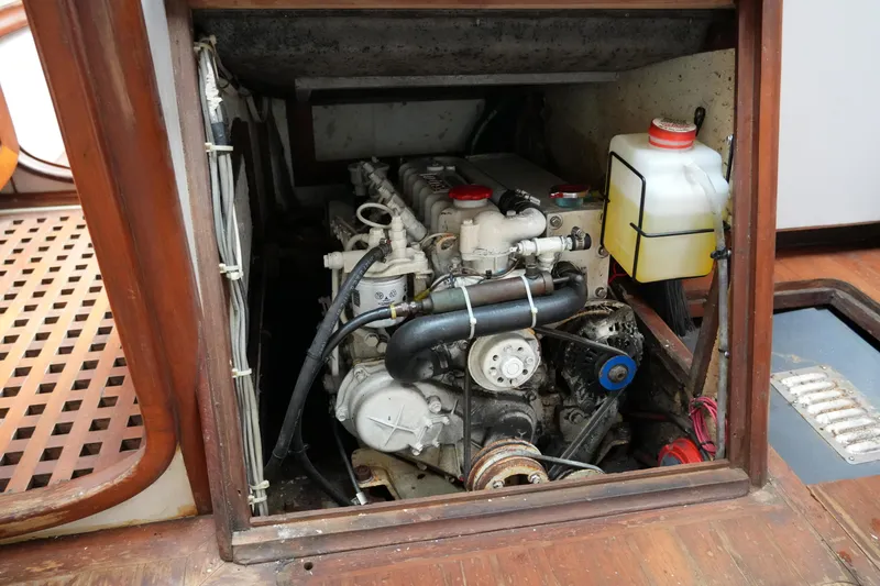 Slide: The Image of Engine compartment of a 1980 Lafitte 44 Cutter sailboat, showcasing mechanical components. - 45