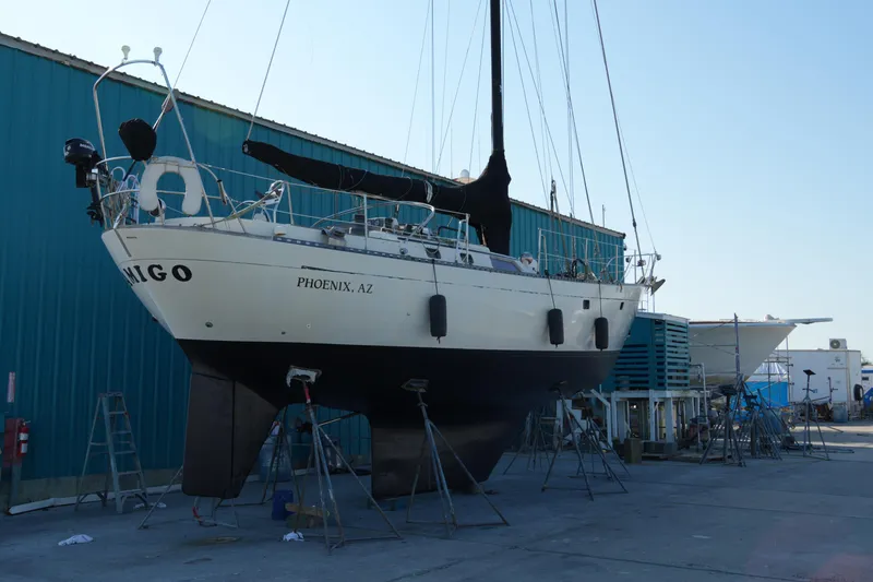 Slide: The Image of 1980 Lafitte 44 Cutter sailboat on stands in a shipyard. - 46