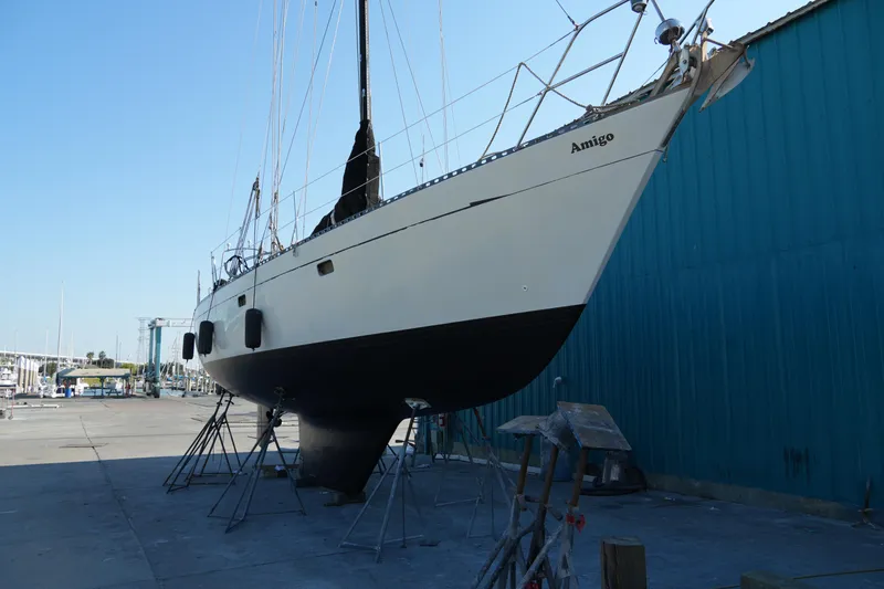 Slide: The Image of 1980 Lafitte 44 Cutter sailboat on dry dock, side view. - 48