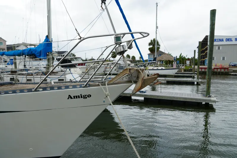 Slide: The Image of 1980 Lafitte 44 Cutter sailboat docked at marina, named "Amigo." - 5