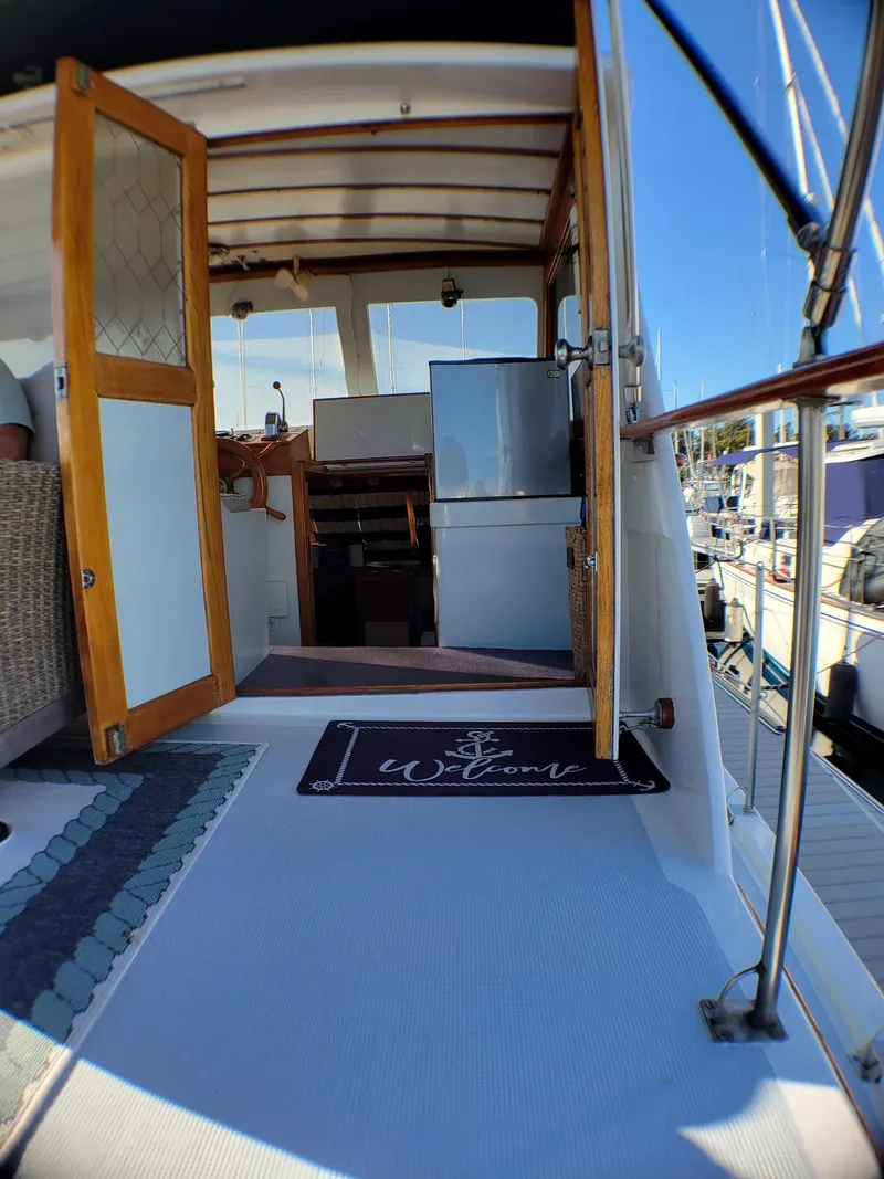 Slide: The Image of 1981 Roughwater 41 Pilot House interior with open door and nautical decor. - 13