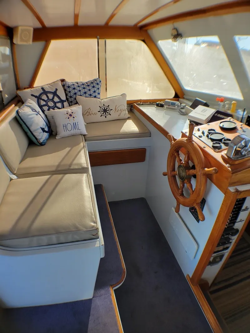 Slide: The Image of 1981 Roughwater 41 Pilot House interior with nautical decor and wooden steering wheel. - 15