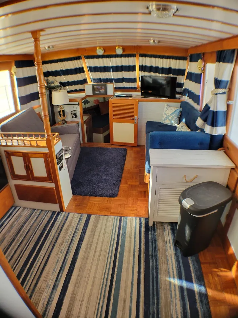 Slide: The Image of Interior of 1981 Roughwater 41 Pilot House with nautical decor and cozy seating area. - 18