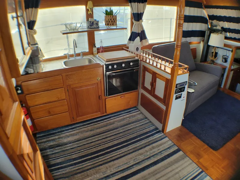Slide: The Image of Interior of 1981 Roughwater 41 Pilot House with kitchen and seating area. - 22