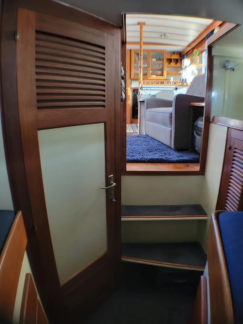 Slide: The Image of Interior view of 1981 Roughwater 41 Pilot House with wooden door and steps leading to cabin. - 29