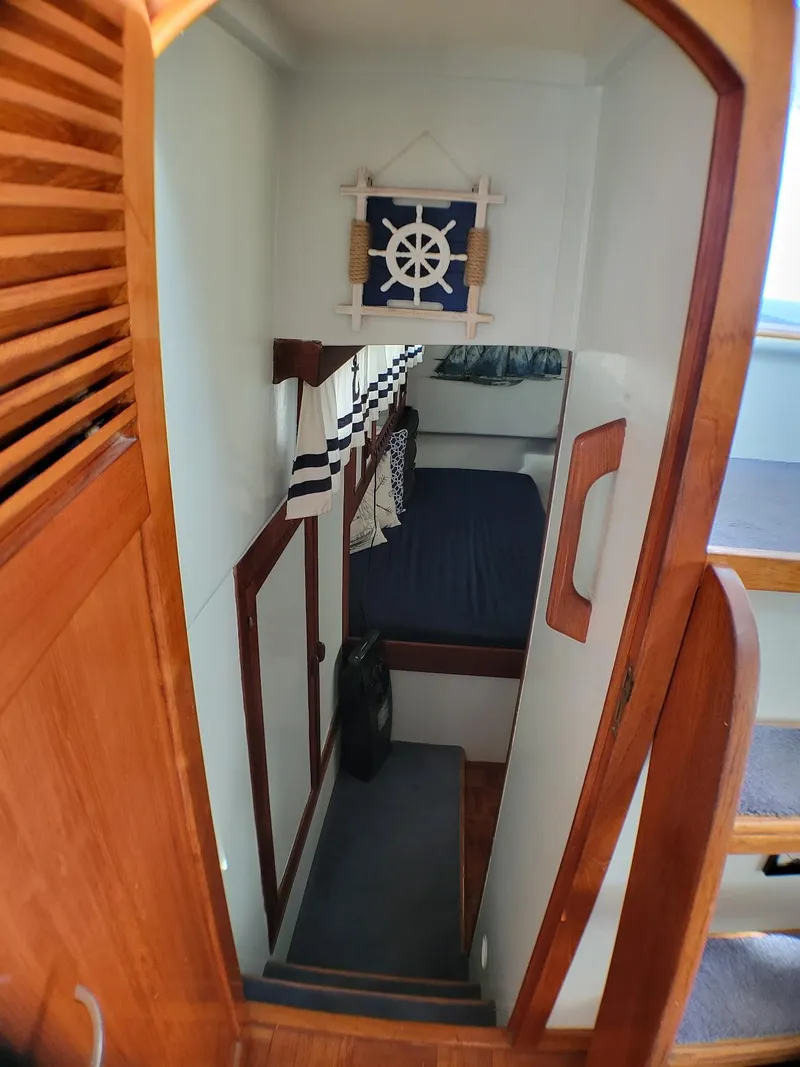 Slide: The Image of 1981 Roughwater 41 Pilot House interior with wooden stairs and nautical decor. - 30