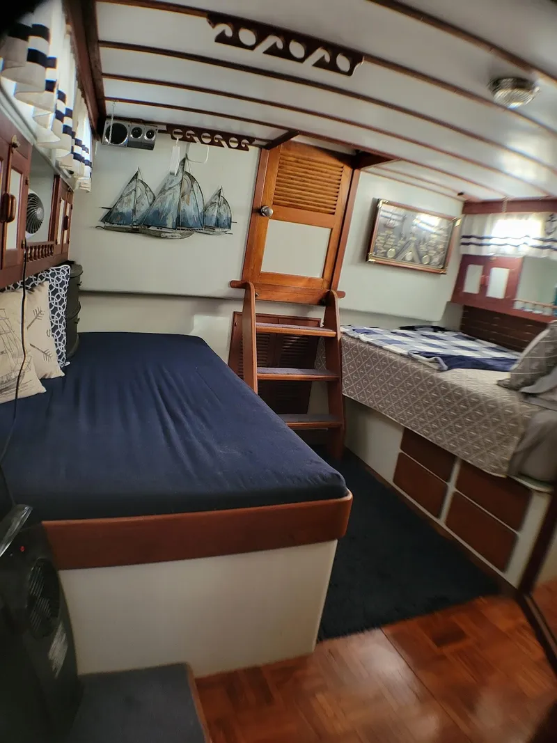 Slide: The Image of 1981 Roughwater 41 Pilot House interior with cozy beds and nautical decor. - 32