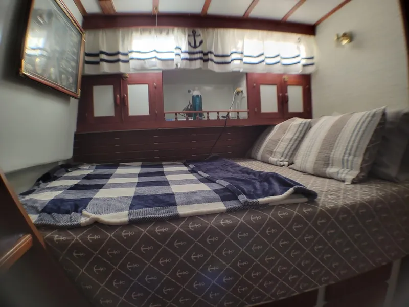 Slide: The Image of Cozy cabin interior of 1981 Roughwater 41 Pilot House with nautical decor. - 33