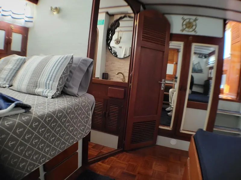 Slide: The Image of Interior of 1981 Roughwater 41 Pilot House with cozy bed and wooden decor. - 34