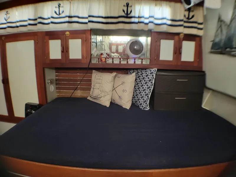 Slide: The Image of Cozy cabin interior of 1981 Roughwater 41 Pilot House with nautical decor and bedding. - 35