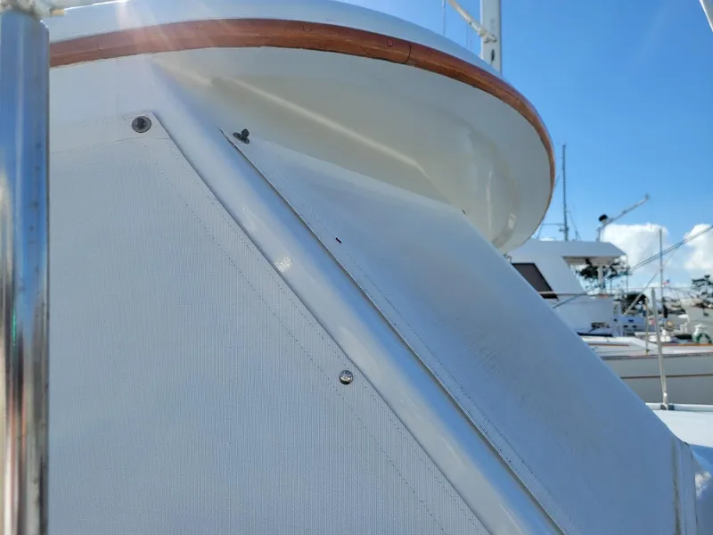 Slide: The Image of 1981 Roughwater 41 Pilot House boat detail with blue sky background. - 7
