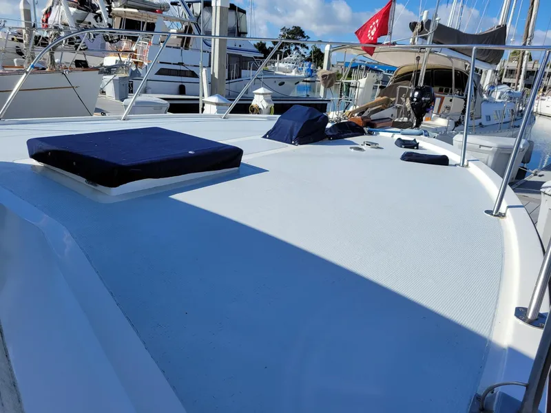 Slide: The Image of 1981 Roughwater 41 Pilot House boat deck with railing and marina background. - 8