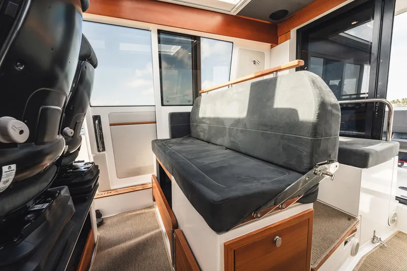 Slide: The Image of Interior of 2023 Nimbus Commuter 11 boat with cushioned seating and modern design. - 15