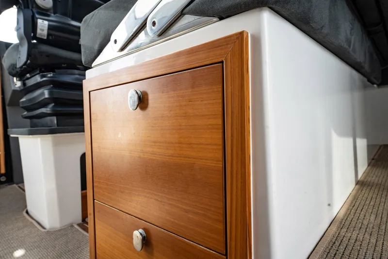 Slide: The Image of Wooden storage drawers in 2023 Nimbus Commuter 11 boat interior. - 16