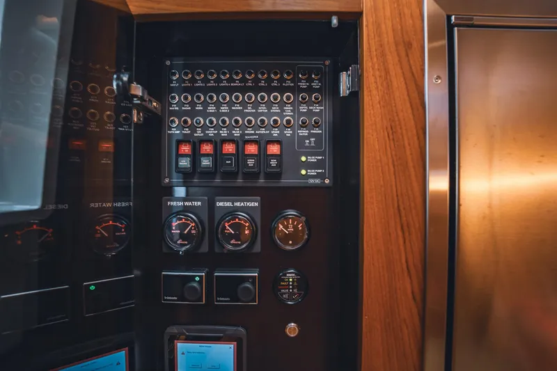 Slide: The Image of Control panel of 2023 Nimbus Commuter 11 with gauges and switches. - 25