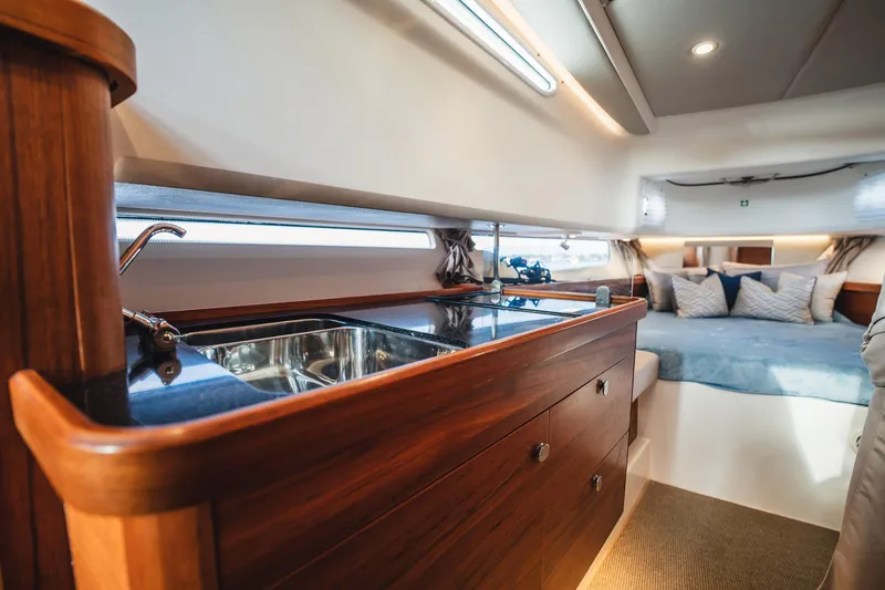 Slide: The Image of Luxurious interior of 2023 Nimbus Commuter 11 yacht with wooden cabinetry and cozy seating. - 27