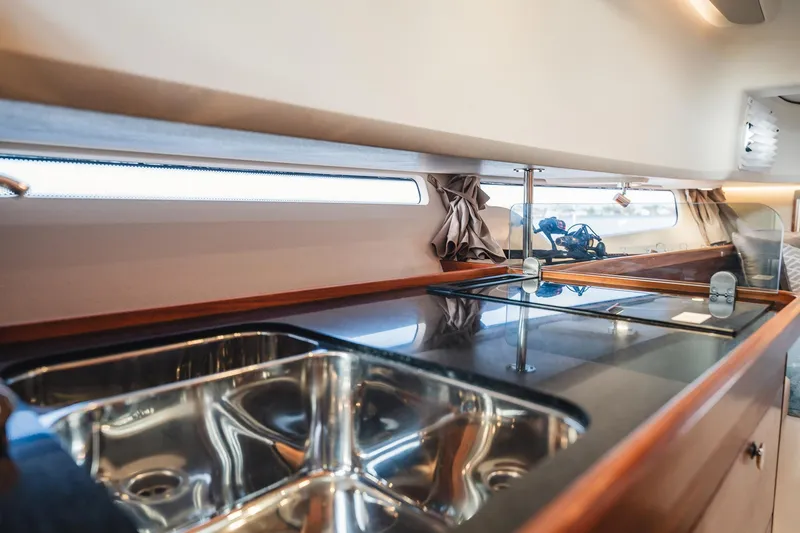 Slide: The Image of Modern kitchen interior of 2023 Nimbus Commuter 11 boat with sleek sink and countertop. - 28