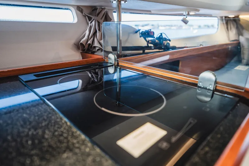 Slide: The Image of Modern kitchen area in 2023 Nimbus Commuter 11 boat, featuring sleek induction cooktop. - 29