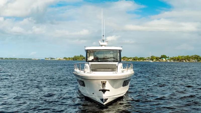 Slide: The Image of 2023 Nimbus Commuter 11 boat on open water under a blue sky. - 3